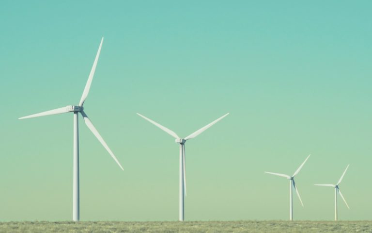 a group of wind turbines in a field